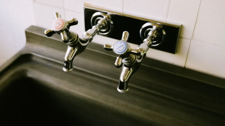 Two chrome sink faucets with hot and cold handles