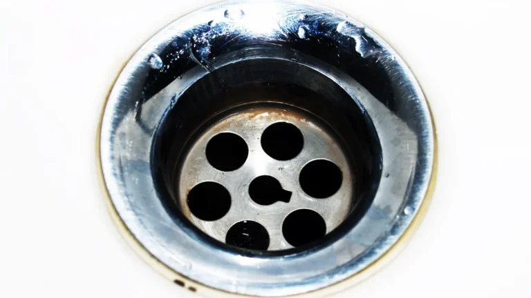 Stainless steel sink drain with water droplets